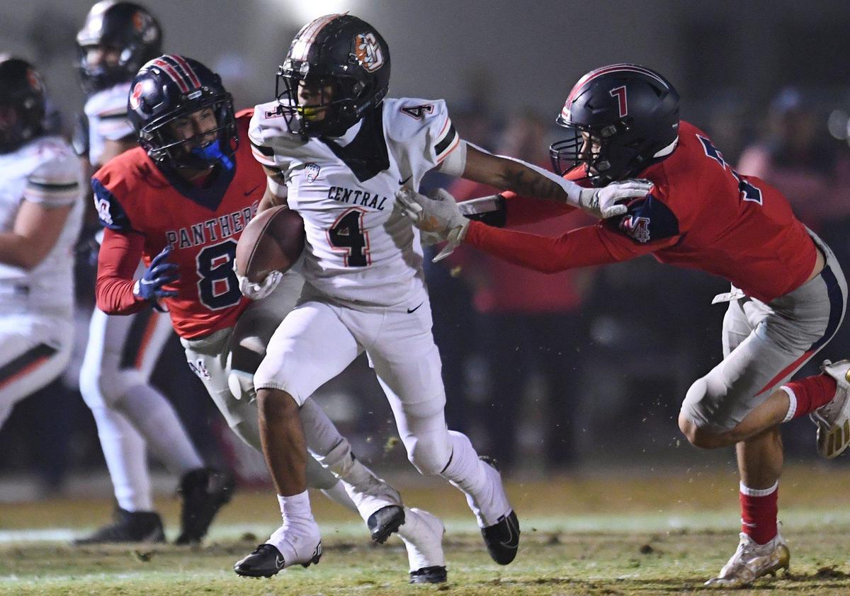 Central running back Jesiah Lindsey, left, outruns San Joaquin Memorials’ Brandon Ramirez, left, and Brandon Rangel, right, in a Central Section semifinal game on Friday, Nov. 19, 2021 in Fresno. Central won 37-20.