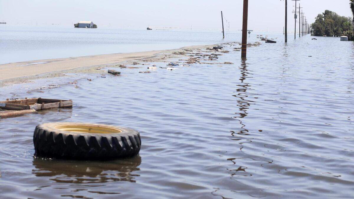 Southbound 6th Avenue as it disappears beneath the widespread flooding Tuesday, April 25, 2023 south of the City of Corcoran where flooding is re-creating the old Tulare Lake.