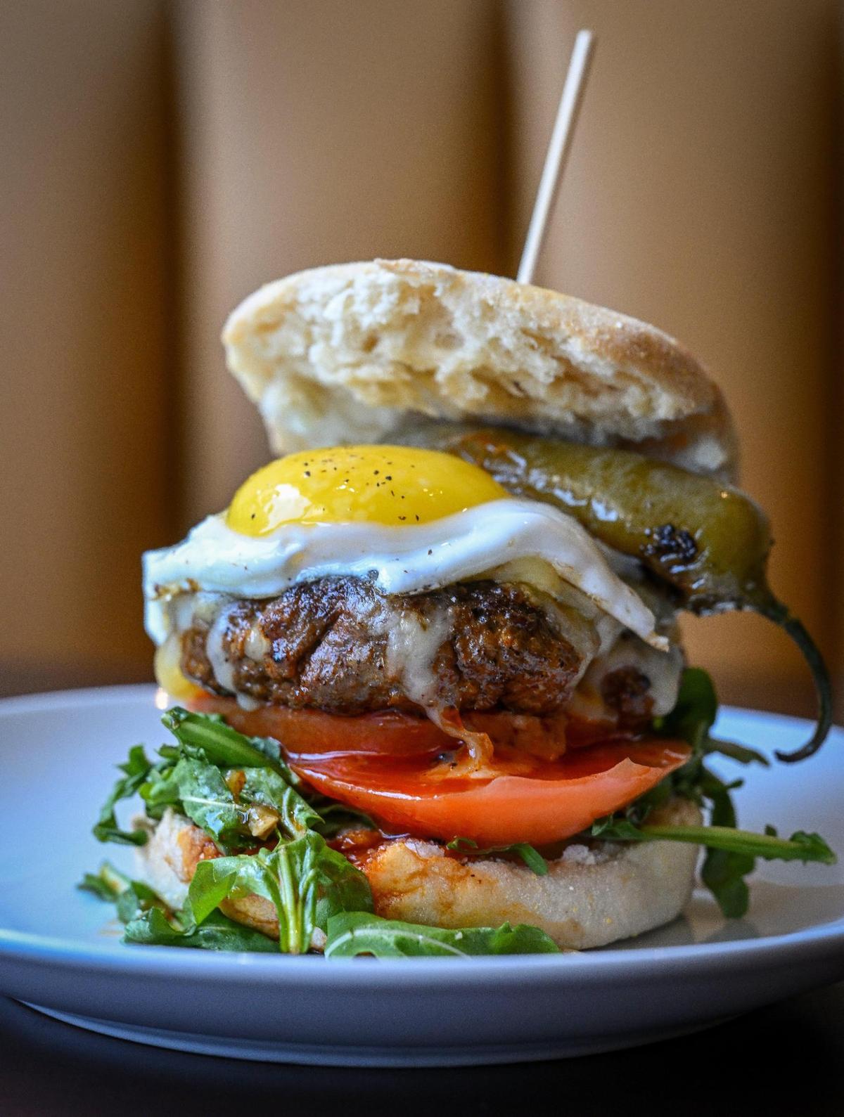 The Branch Burger at Branch Breakfast Co. is a beef-chorizo house blend burger topped with an egg and roasted jalapeño with tomato, arugula, Oaxaca cheese and ranchero aioli.