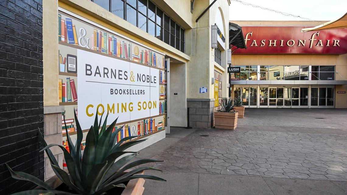 Signs show that a Barnes & Noble bookstore location is opening soon near the main entrance to Fashion Fair mall in Fresno.
