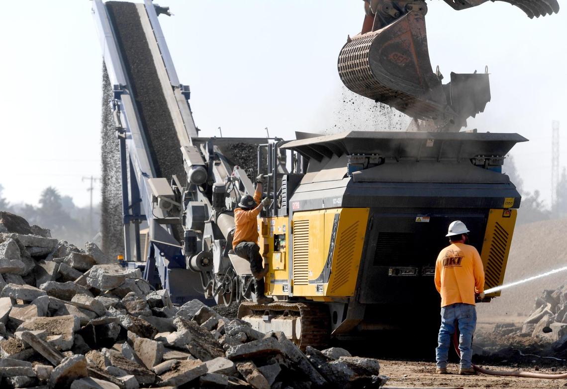 Excavated concrete is pulverized during construction of the new 183,000-square-foot Amazon ‘last mile’ warehouse in east Fresno, Feb. 9, 2022. The site is wrapped around the former Sunnyside Drive-In at Olive and Clovis avenues.