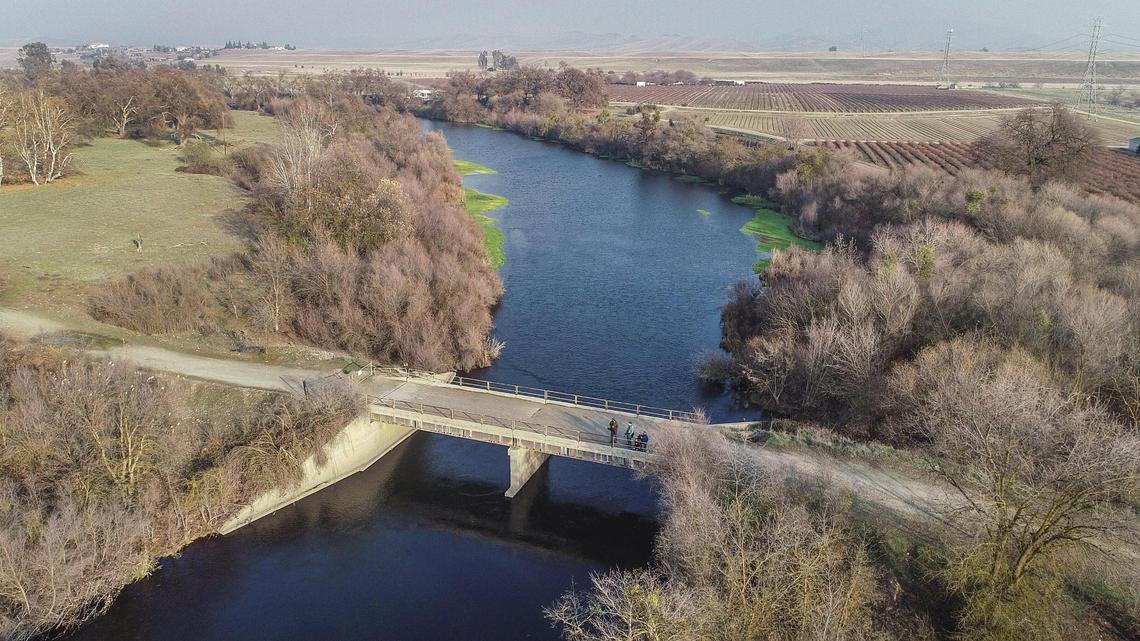 A bridge connecting Ledger Island, left, and the former Sumner Peck Ranch at the San Joaquin River appears in this drone image on Thursday, Jan. 7, 2021. The Sumner Peck Ranch land was recently acquired by the San Joaquin River Parkway and Conservation Trust with long-term plans to restore the site to wildlife habitat with a natural surface trail system.