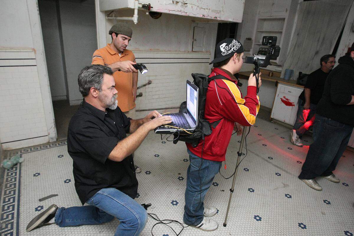 Director Scott Gruenwald works at a laptop computer during a live web show on paranormal investigations filmed at Wolfe Manor in Clovis on Sunday, Nov. 16,2008.