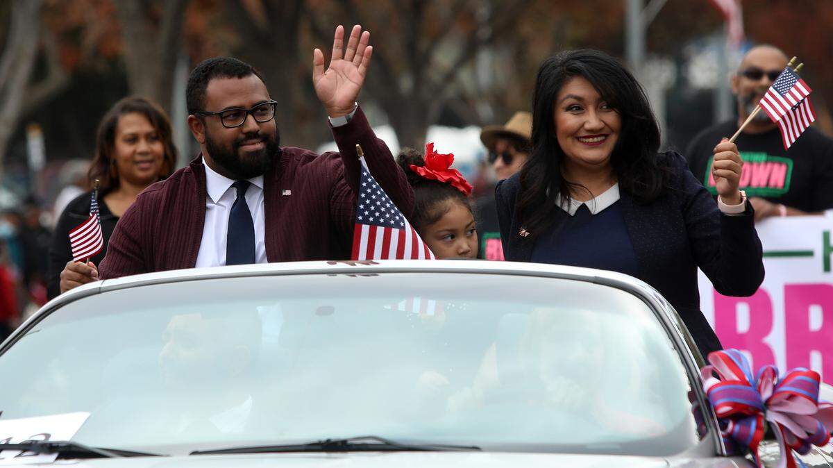 Fresno City Councilmember Nelson Esparza and Sandra García wave along the Central Valley Veterans Day Parade route.