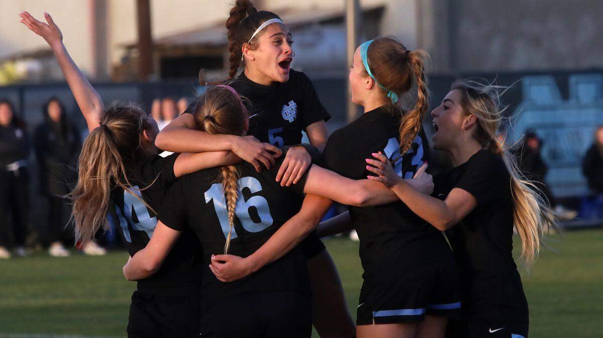Clovis North players celebrate a goal by No. 16 Braedyn Kincade in the second overtime period of a CIF Central Section Division I girls soccer semifinal on Feb. 21, 2023. Clovis North won, 2-1, in overtime to advance to the championship match.