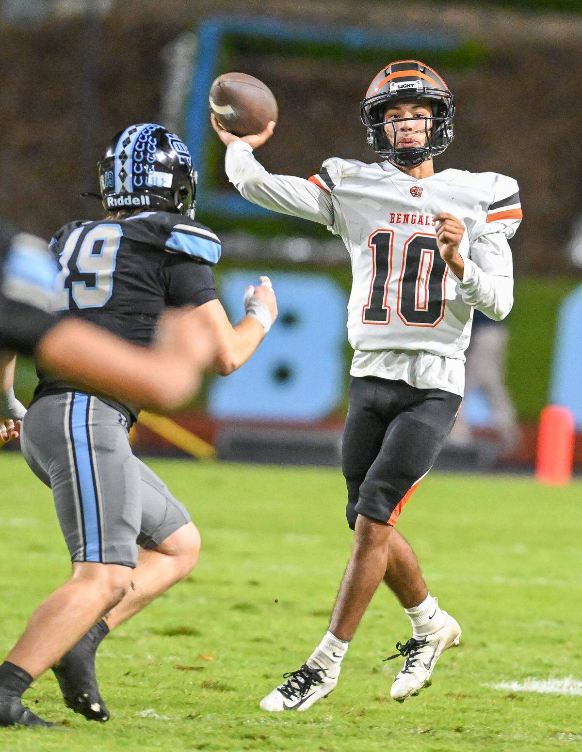 Central East quarterback Jelani Dippel makes an off-balance throw while getting pressure from Clovis North's Cole McCullough during their TRAC opener at Veterans Memorial Stadium in Clovis on Thursday, October. 2, 2025.