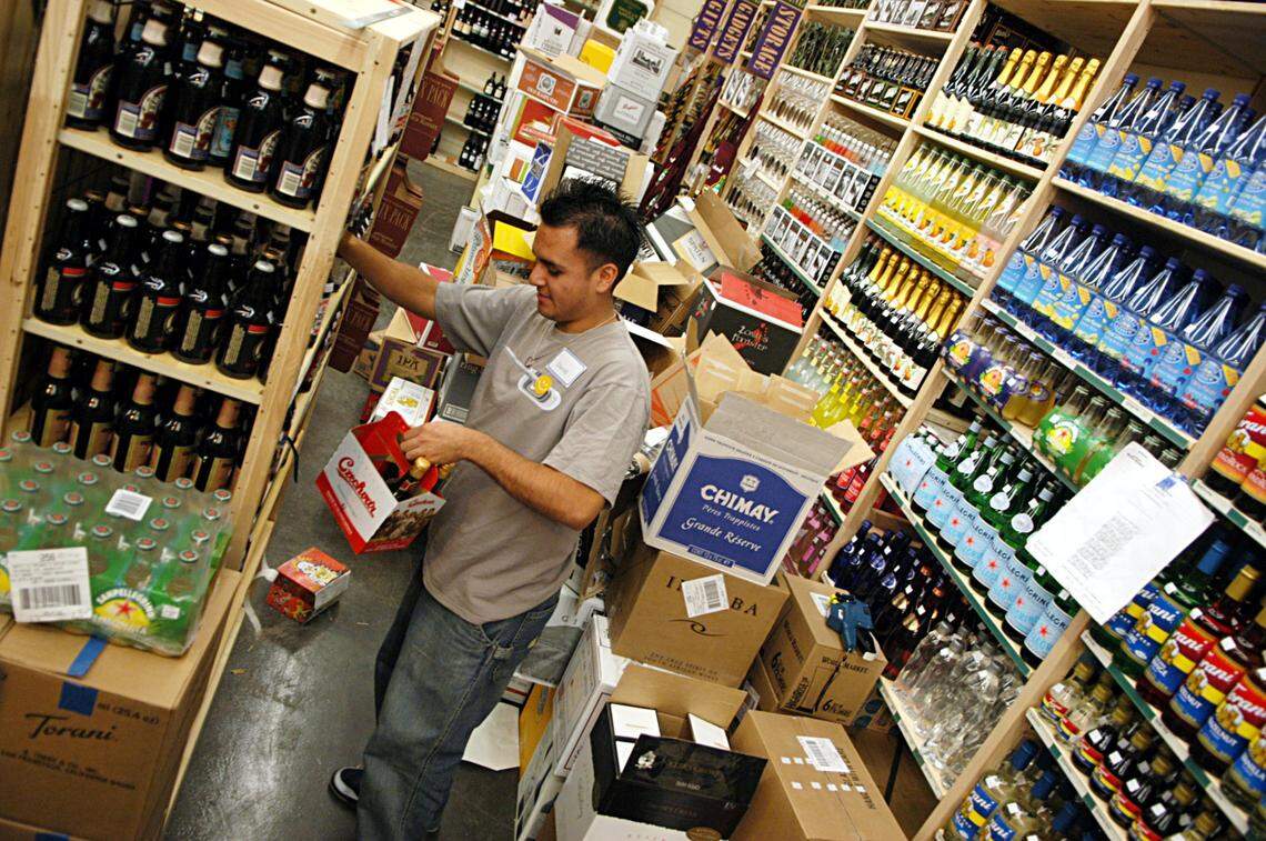 David Santiago, an employee at the World Market in Visalia, stocks shelves in this Fresno Bee file photos from 2004. The store is closing, though the Fresno location will remain open.