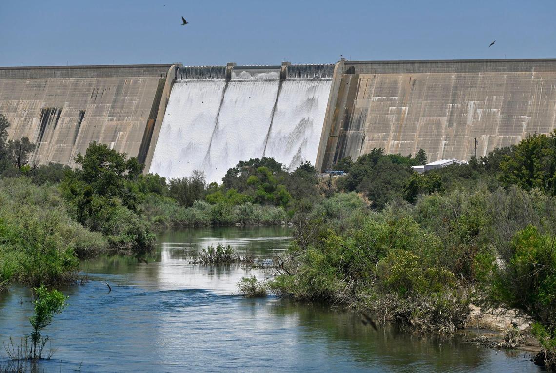 Friant Dam releases water from Millerton Lake into the San Joaquin River, foreground, Saturday, July 15, 2023 near Friant.