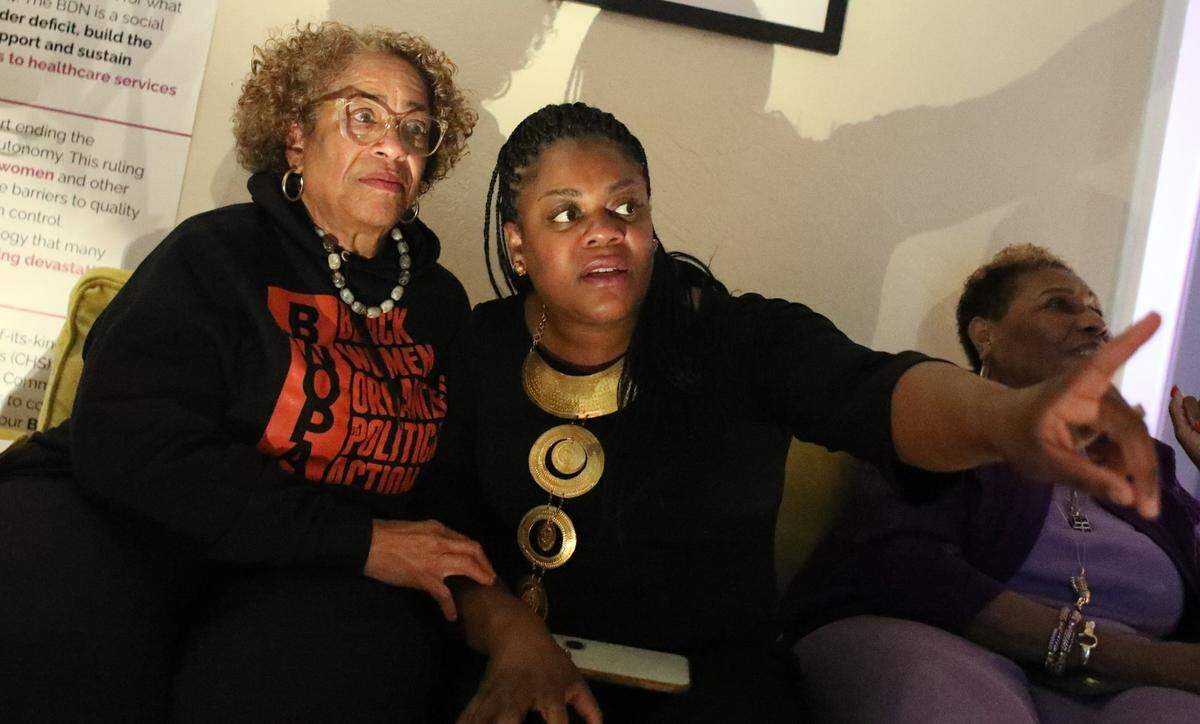 Shantay R. Davies-Balch, president and CEO of the BLACK Wellness & Prosperity Center in Fresno, speaks with former Fresno City Councilmember Cynthia Sterling (left) at the organization’s headquarters during Art Hop on April 3, 2025.