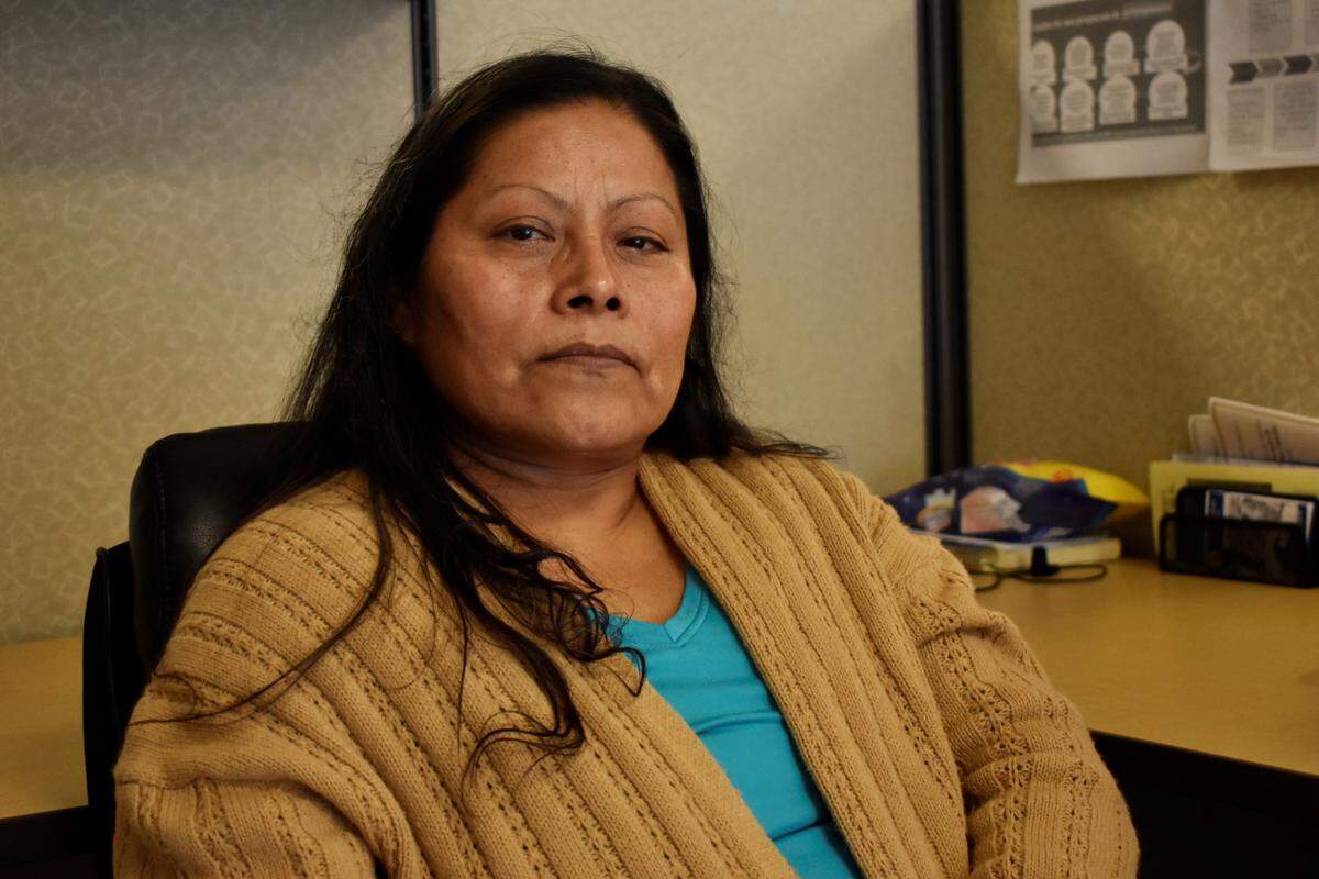 Emelia Guzmán, 52, looks at the camera while sitting at the Centro Binacional para el Desarollo Indígena Oaxaqueño, or the Binational Center for the Development of Indigenous Oaxacans, in Madera on Wednesday, Jan. 18, 2023. Guzmán collapsed while working in the fields in Madera in 2019. She was sent to Madera Community Hospital, where a biopsy confirmed she had breast cancer that hadn’t been diagnosed at a clinic before. Still under medical watch, she is now left without primary and specialist care after the Madera community Hospital closed.