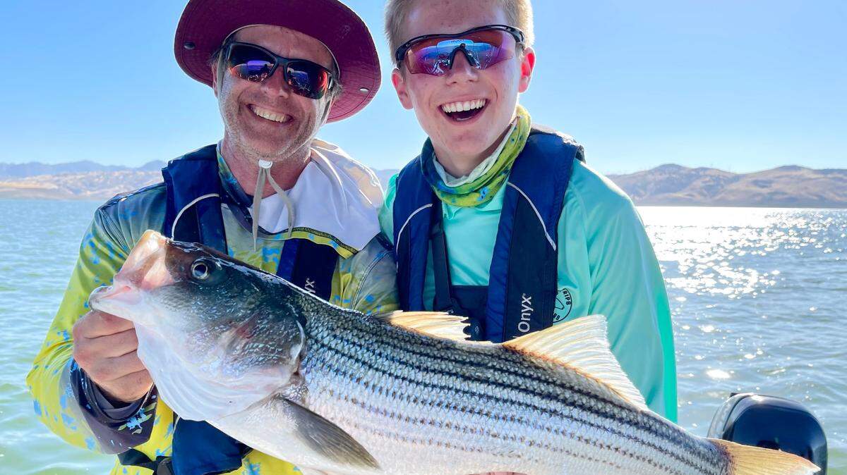 Martin Dieck and son Logan from Palo Alto with a striper that was released on a San Luis Reservoir trip Sept. 12 with guide Roger George.