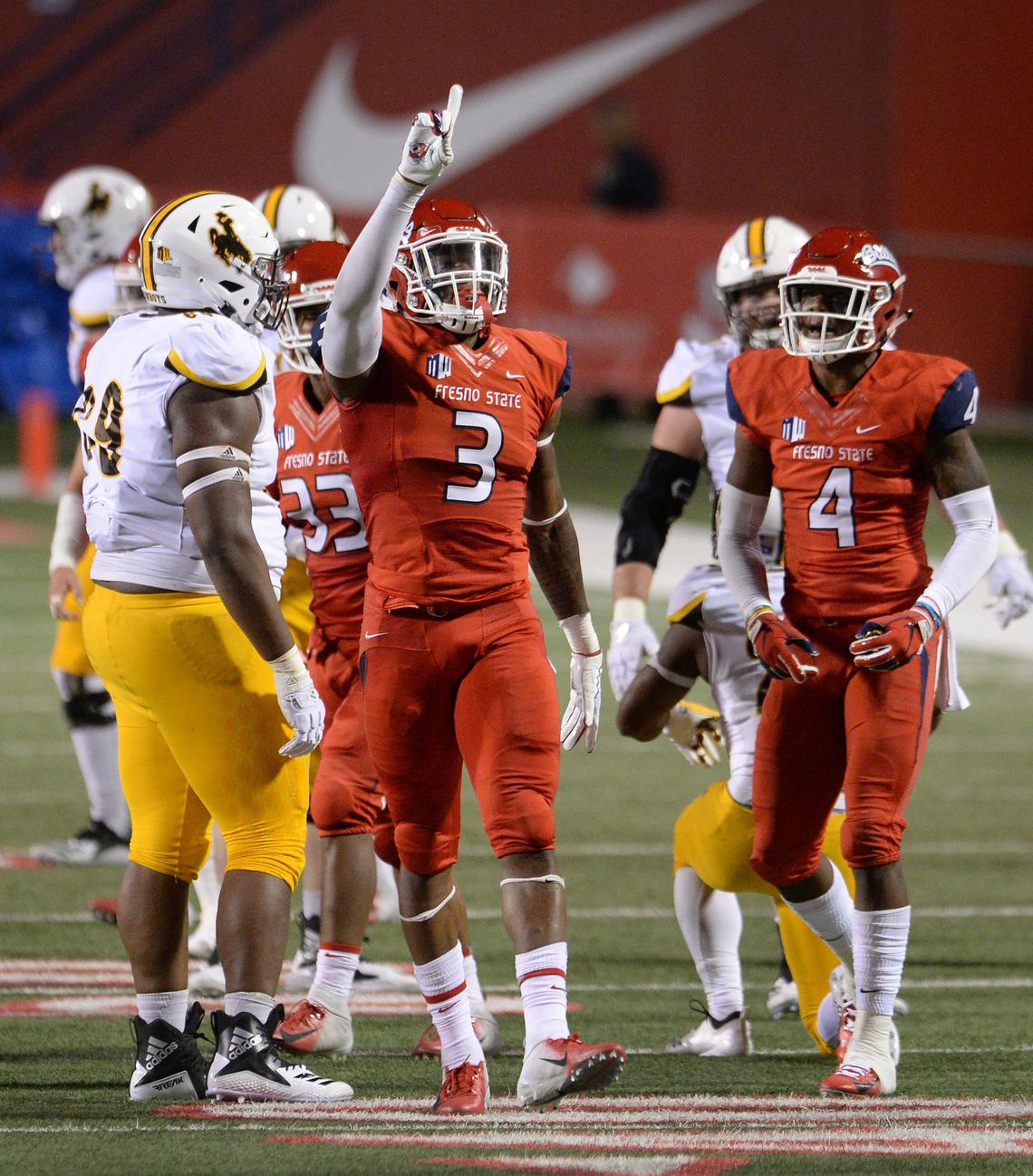 Fresno State defensive end Mykal Walker, center, celebrates a tackle for a loss with teammate Mike Bell during a 27-3 victory over the Wyoming Cowboys at Bulldog Stadium in Fresno on Saturday, Oct. 13, 2018. The Bulldogs allowed only 221 yards of offense and 14 first downs in the victory.