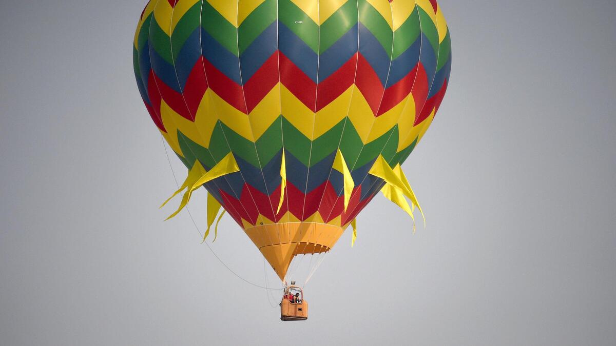 Drifting in the breeze, a balloon takes flight at the Hot Air Balloon Fun Fly, kicking off ClovisFest early Saturday, Sept. 25, 2021, from the Rodeo Grounds in Clovis, California. ClovisFest, spanning 12 blocks, offers craft, commercial and food booths and runs through Sunday.