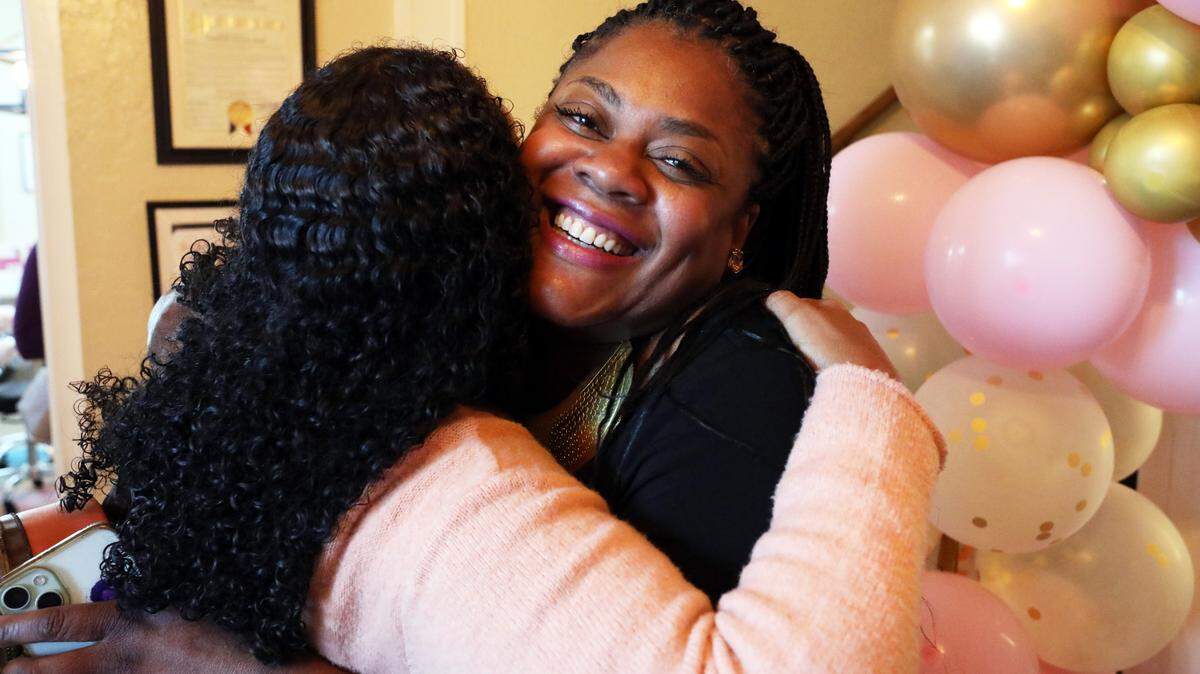 Shantay R. Davies-Balch, president and CEO of the BLACK Wellness & Prosperity Center in Fresno, greets a visitor to the organization’s headquarters during Art Hop on April 3, 2025.
