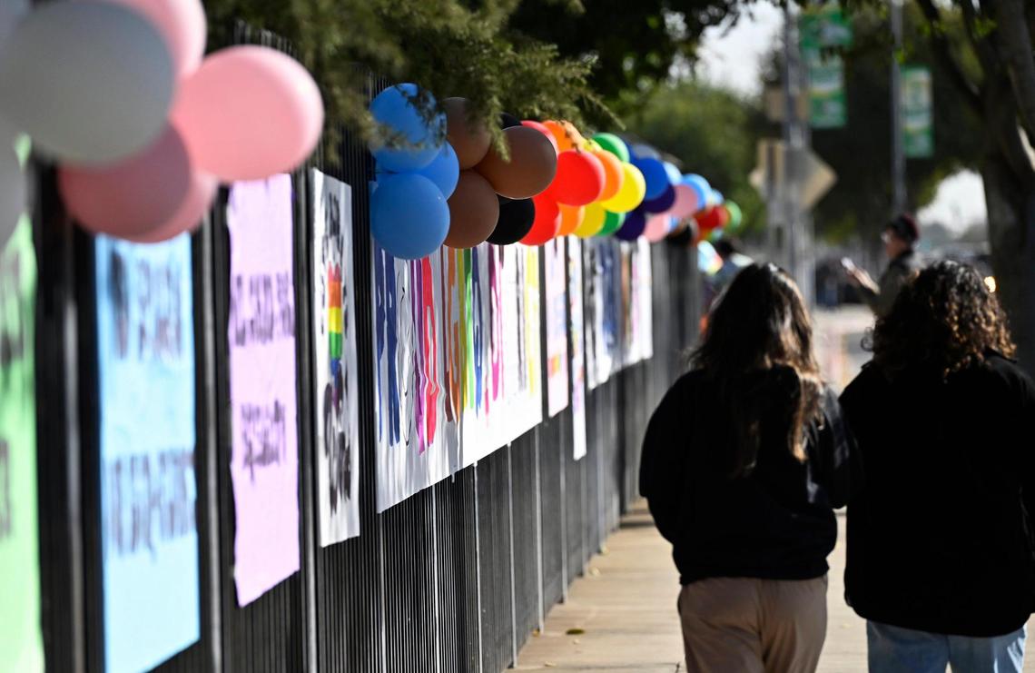 Colorfuk signs on the fence along Cedar Avenue are seen as a coalition of LGBTQ+ organizations, headed by LGBT+ Fresno, held a counter-protest outside Roosevelt Hgh School featuring rainbow-themed umbrellas as symbolic shields against a group from Westboro Baptist Church Monday, Oct. 28, 2024, Fresno.