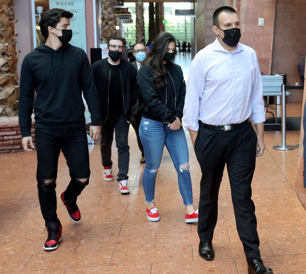 The family of victim Tina O. Tintor walk out of the Regional Justice Center in Las Vegas, Wednesday, Nov. 3, 2021, after the initial court appearance of former Raiders wide receiver Henry Ruggs III in connection with a fiery crash that left the 23-year-old woman dead. Tintor died with her dog in a wrecked and burned Toyota Rav4, according to police. Records show she lived several blocks from where the crash occurred.