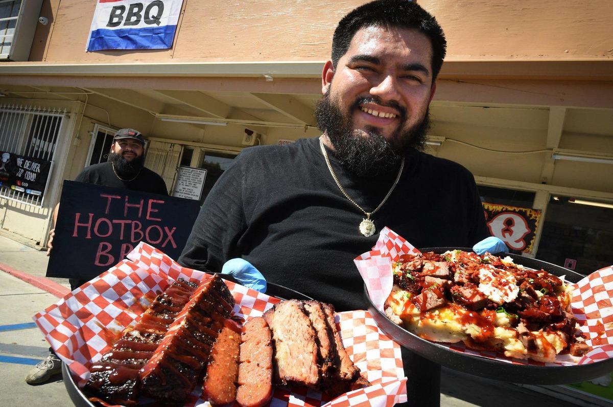 Longtime buddies Esteban Guiverra, right, and Ivan Matamoros, both veteran area cooks, are fulfulling their dream of having their own eatery, The Hotbox BBQ, in keeping with a Fresno trend, inside a Valero gas station at Maple and Shields avenues. Guiverra says their potential is “to the moon.”