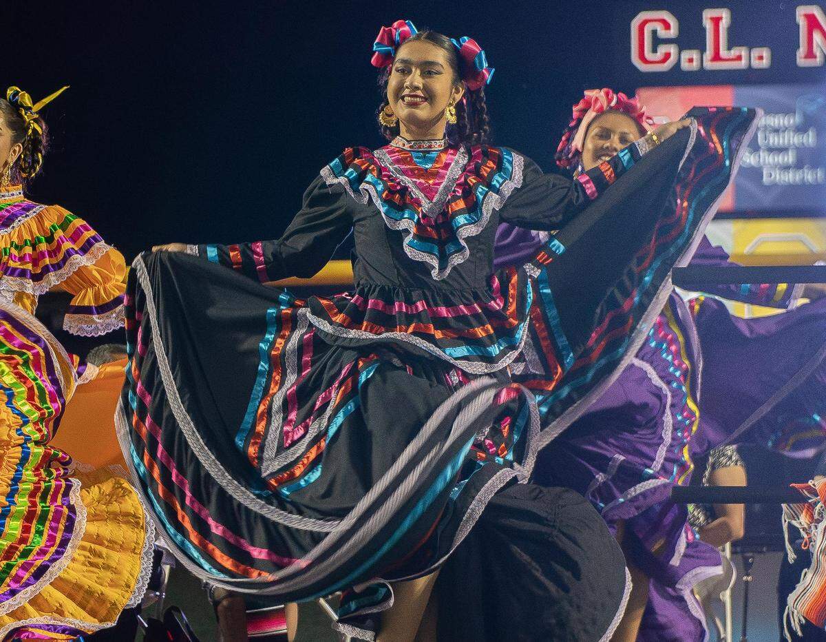 Belén Preciado, right, of the Edison High Folclórico dances during the inaugural Latinx High School Recognition Celebration at McLane High Stadium on June 4, 2023.