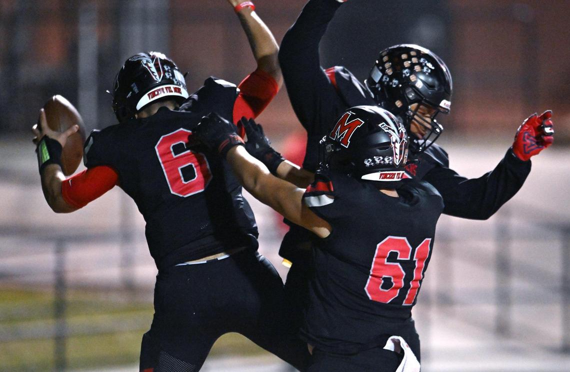 McLane celebrates quarterback Noah Zamora’s touchdown, left, against Hoover Friday, Nov. 1, 2024 in Fresno.