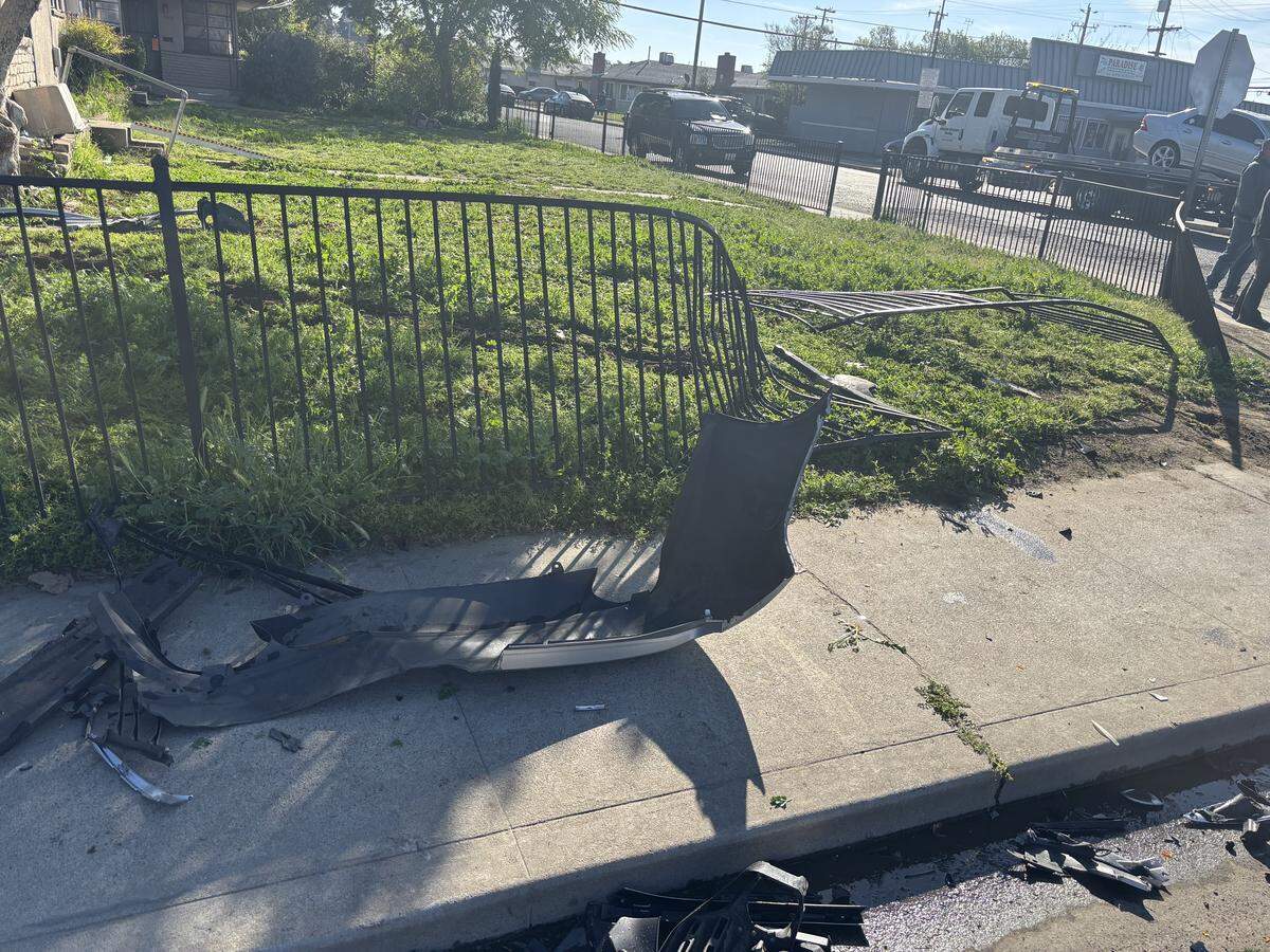 Aftermath of the three-vehicle crash Tuesday morning that resulted in a car hitting a wrought iron fence in front of an apartment.