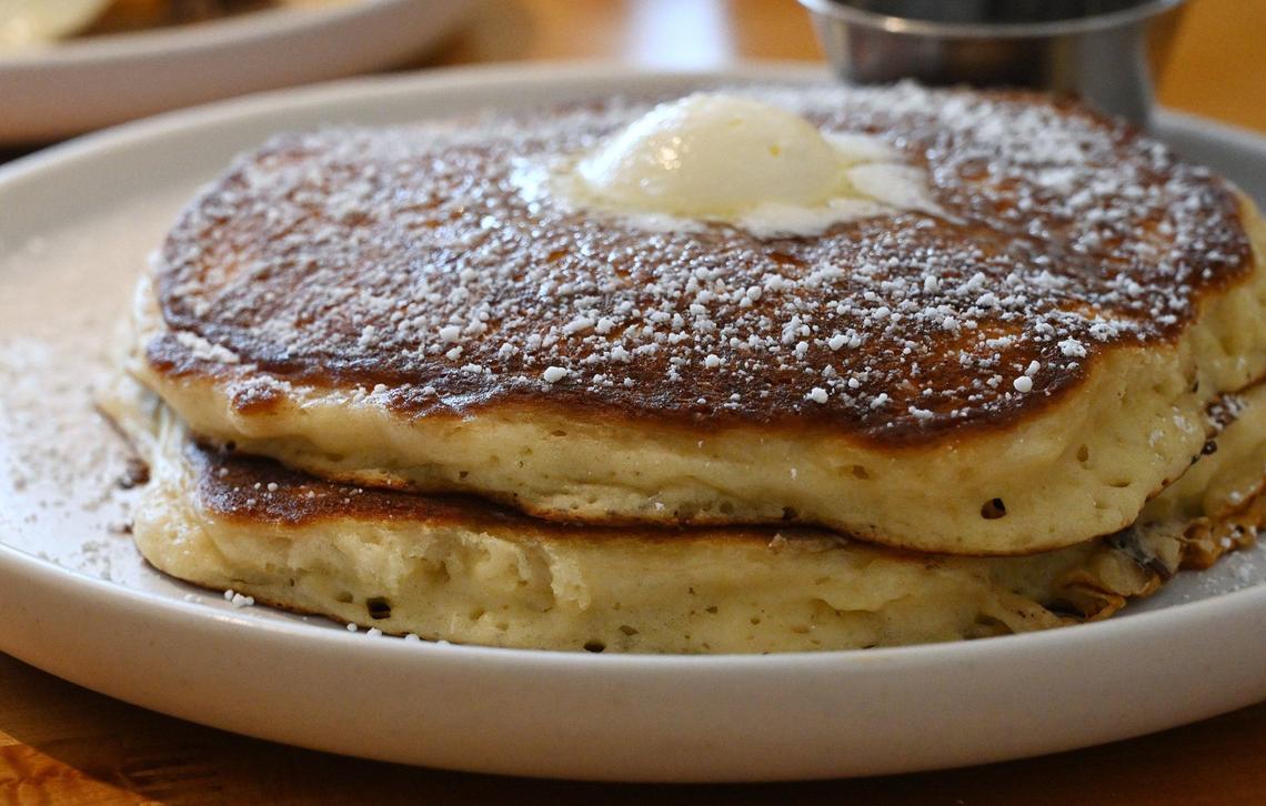Stackin’ Cakes, a pair of homemade buttermilk pancakes with whipped butter and a dusting of powdered sugar, is served at Yolked Kitchen. Photographed Thursday, July 11, 2024 in Clovis.