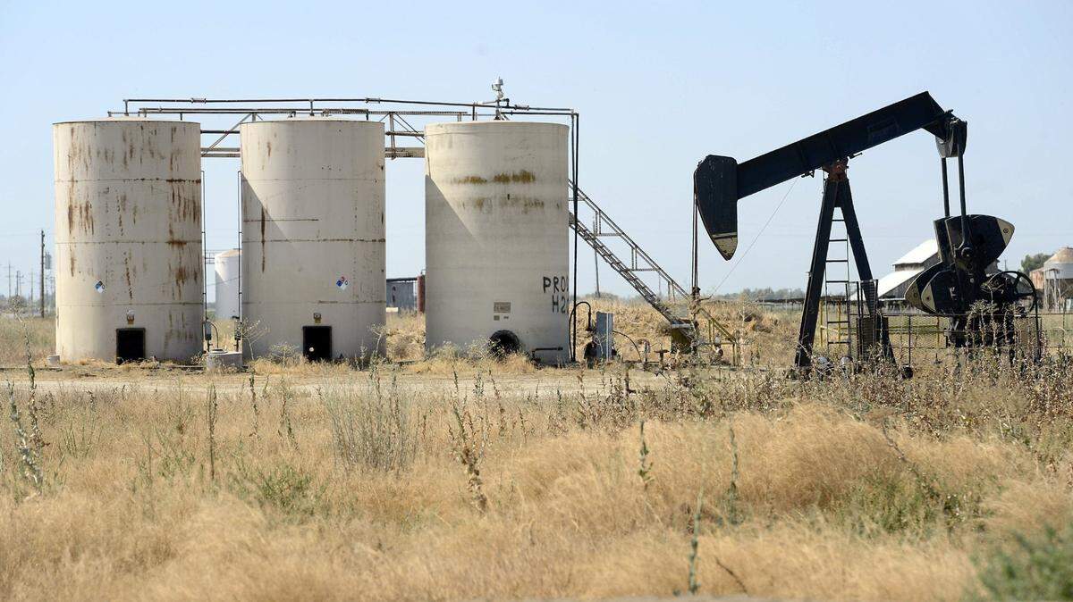 An oil pump jack and tanks are visible just outside Riverdale in this file photo. Scattered throughout the agricultural fields of Fresno County are thousands of oil and gas wells.