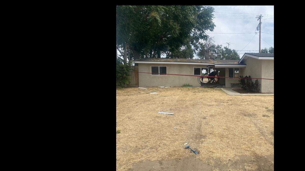 Damage is seen at a Visalia home where a pickup crashed through the house, then through a fence and into a big rig Saturday, May 22, 2021.