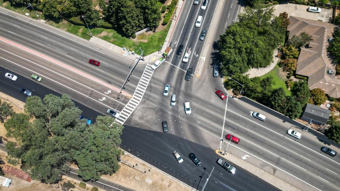 Traffic crosses the intersection at Shepherd Avenue and Friant Road on Monday, Aug. 5, 2024. Several safety measures have been implemented along a dangerous section of Friant Road in north Fresno including high-visibility crosswalks, reflective signal backplates, and no right turn on red signs.