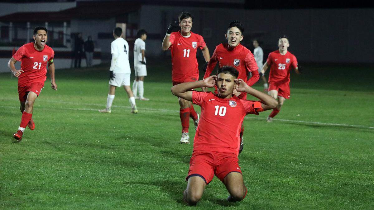 Sanger High midfielder Julio Hernández and his teammates celebrate his goal in overtime that gave the Apaches a 3-2 lead against Clovis East.