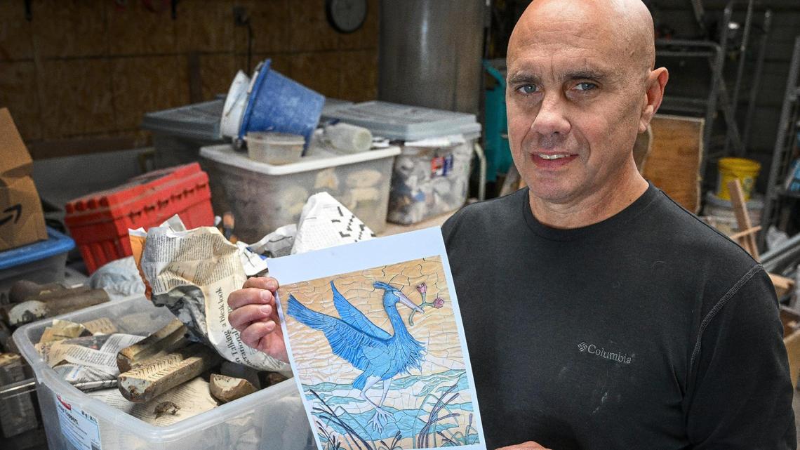 David Roberts shows a photo of a great blue heron ceramic mural that he and a class of University High School students created in 2022. At the moment the pieces of the mural are wrapped up in newspaper and stored in boxes in his garage. He has been trying to find someone willing to invest in having the piece installed along the Lewis S. Eaton Trail in north Fresno to no avail.