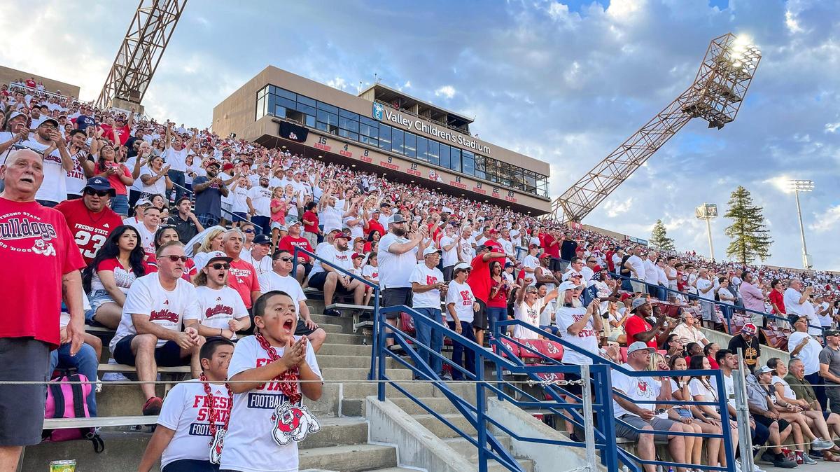 Fresno State fans cheer on the team while dressed mostly in white during their home opener “white out” game against Eastern Washington at Valley Children’s Stadium on Saturday, Sept. 9, 2023. It was the Bulldogs’ first sellout for a home opener since 2014.