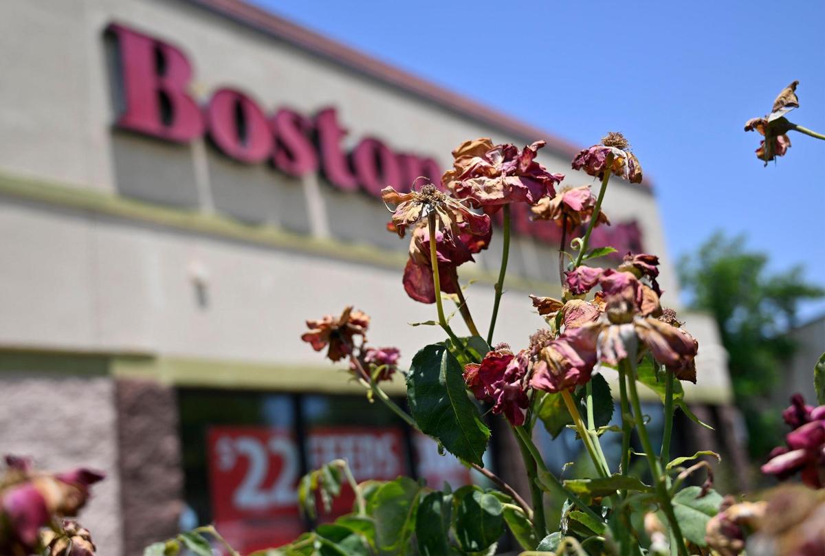 Dying flowers outside the Boston Market on Bullard Avenue at 41, which is temporarily closed according to a sign on the front door. Photographed Friday, June 16, 2023 in Fresno.