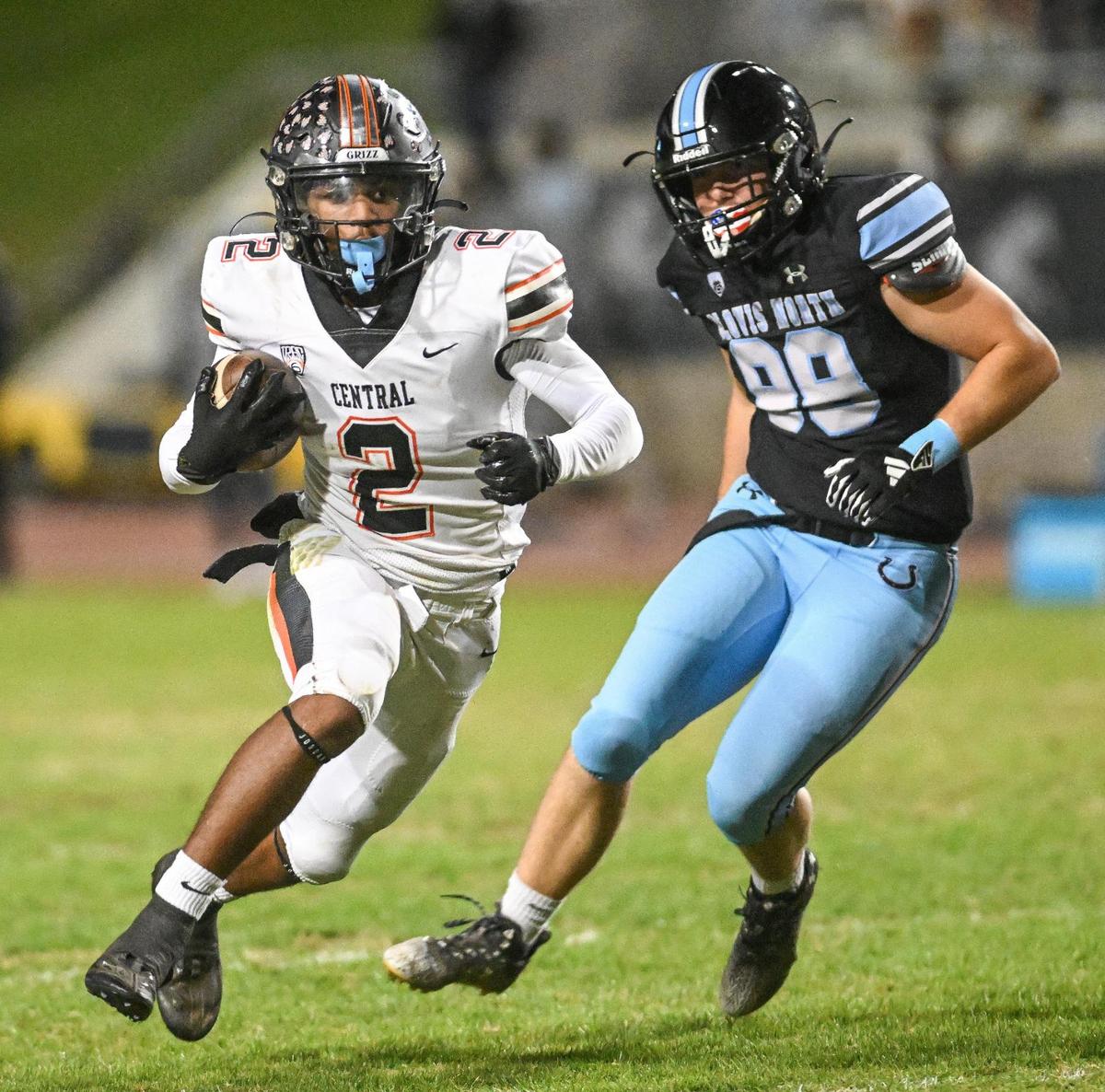 Central’s Brandon Smith, left, finds an opening around Clovis North’s Jack Kirby during their Tri-River Athletic Conference football final at Veterans Memorial Stadium on Thursday, Oct. 26, 2023.