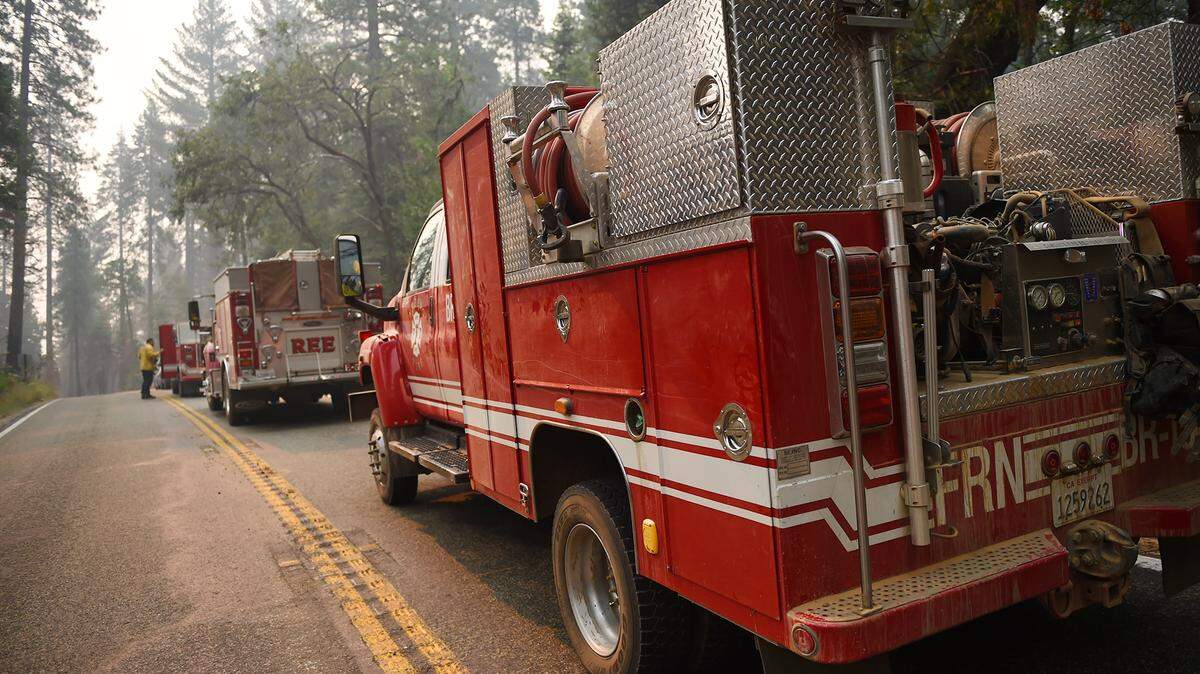 Fresno County fire trucks stopped along Highway 41 on their way to Yosemite Nartional Park Wednesday, July 25, 2018.