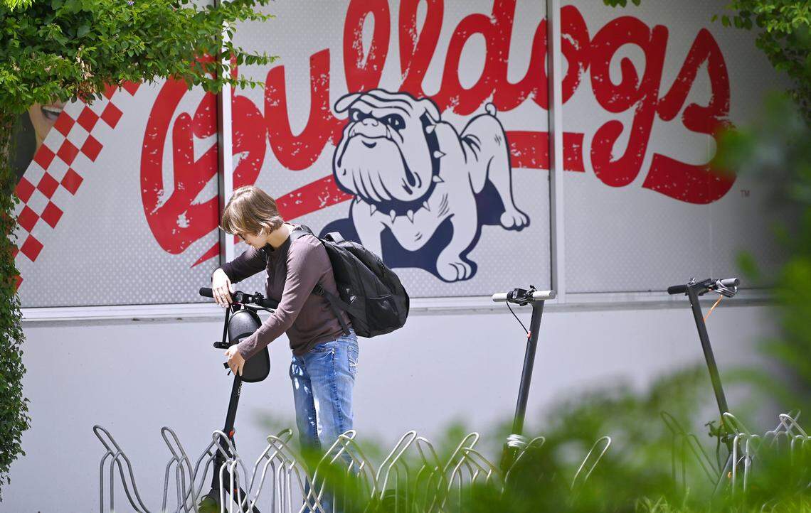 A student unlocks their scooter at Fresno State Monday, April 27, 2026 in Fresno. The university will begin a ban on all motorized scooters, skate boards and bikes starting August 19 this year.