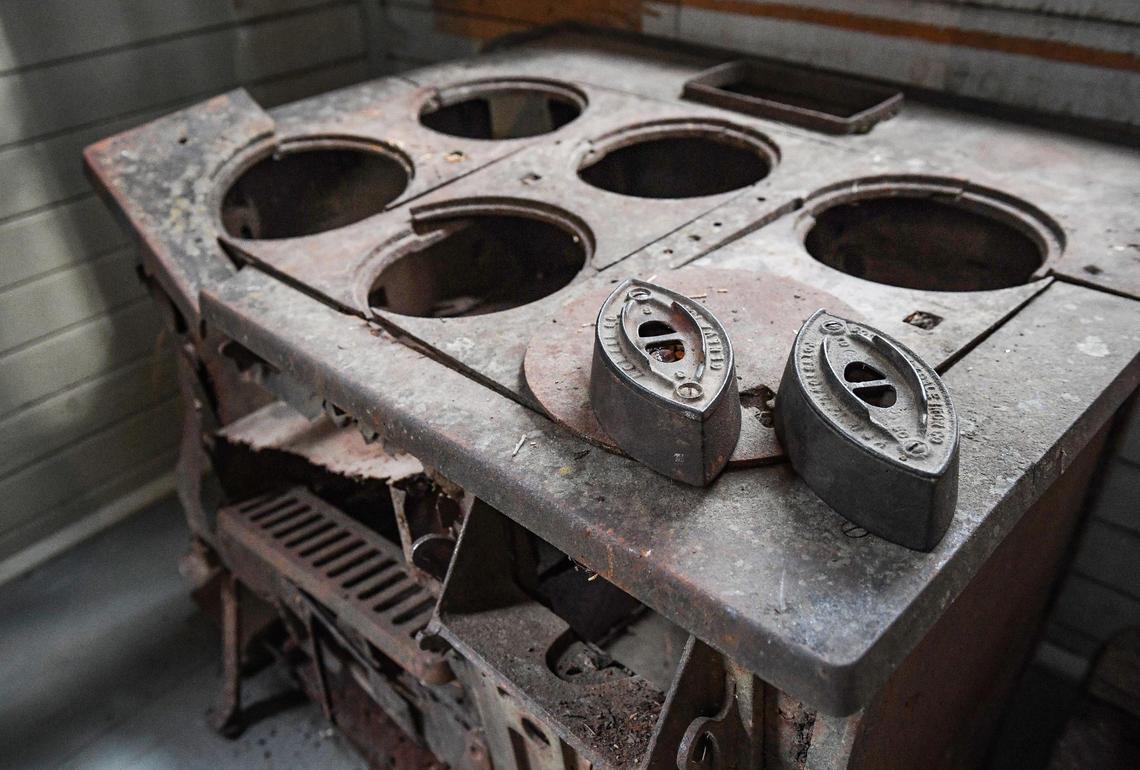 Antique irons sit on an old stove that may have been used in ironing clothing is displayed to illustrate the nature of work once done in the Chinese Laundry Building near the Yosemite History Center in Yosemite’s Wawona on Tuesday, Sept. 28, 2021. The building is being dedicated in honor of its original purpose as a laundry building for the Wawona Hotel and the Chinese immigrants who ran it.