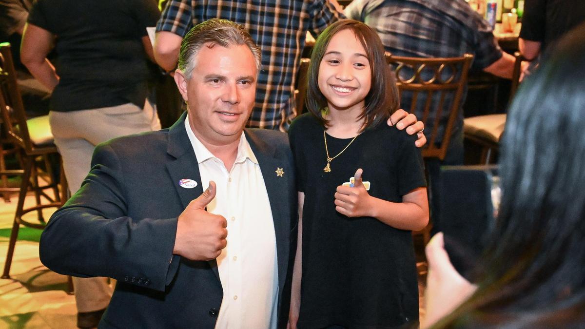 Fresno County Sheriff candidate John Zanoni poses for a photo with a young supporter during a victory celebration at the Fresno Deputy Sheriff’s Association building in downtown Fresno on Tuesday, June 7, 2022.
