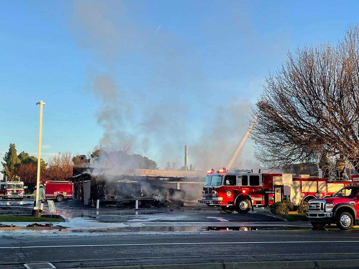 A strip mall at Kings Canyon Road and Phillip Avenue caught fire Friday, Jan. 6, 2023, in southeast Fresno, California. The building was home to Irish O’Sullivan’s Sunnyside Lounge Restaurant and Pub and Sunnyside Deli.