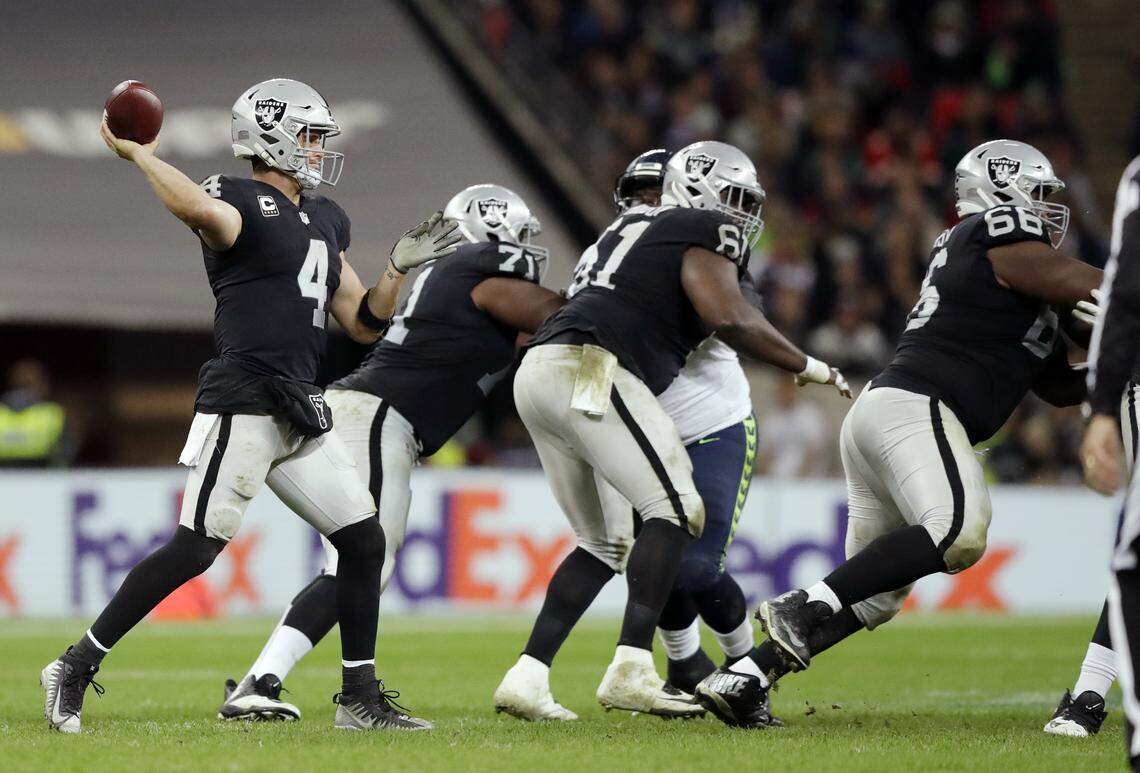Oakland Raiders quarterback Derek Carr (4) passes the ball during the second half of an NFL football game at Wembley stadium in London, Sunday, Oct. 14, 2018.