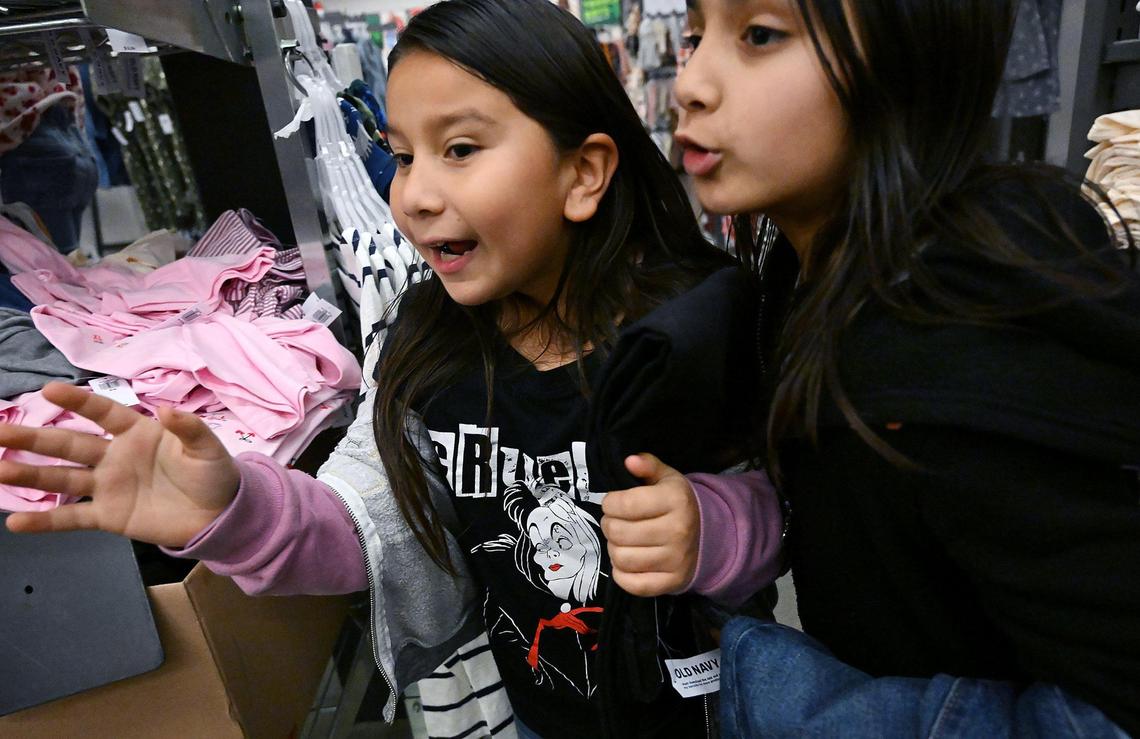 Two young girls from Live Again Fresno excitedly shop in a shopping spree at Old Navy Monday morning, Dec. 18, 2023 in Fresno.