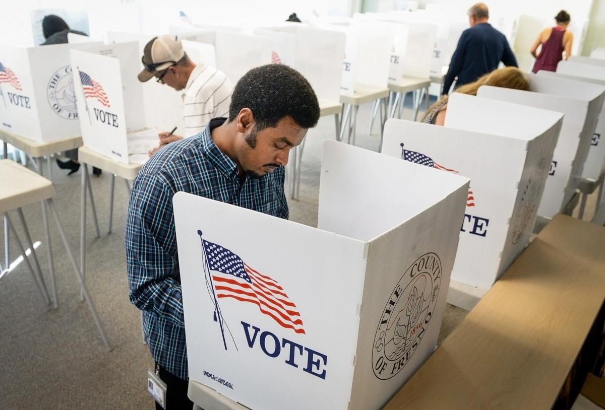 Daniel Tesfai marks his election ballot along with a steady flow of other voters at the Fresno County Elections office in downtown Fresno on Monday, Nov. 5, 2018, on the eve of the national mid-term elections.