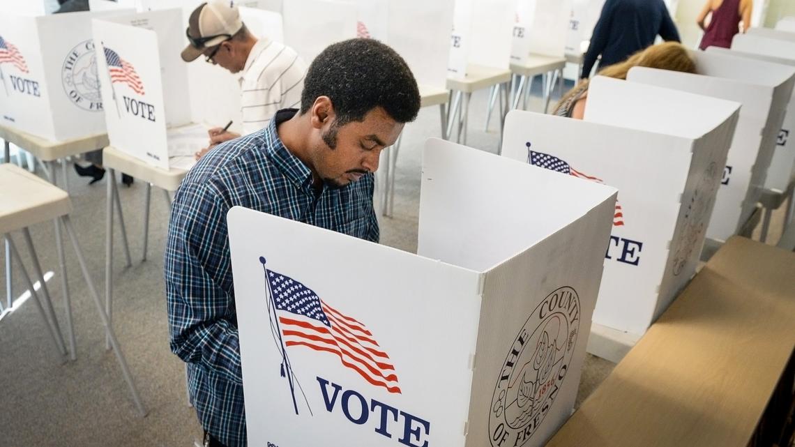 Daniel Tesfai marks his election ballot along with a steady flow of other voters at the Fresno County Elections office in downtown Fresno on Monday, Nov. 5, 2018, on the eve of the national mid-term elections.