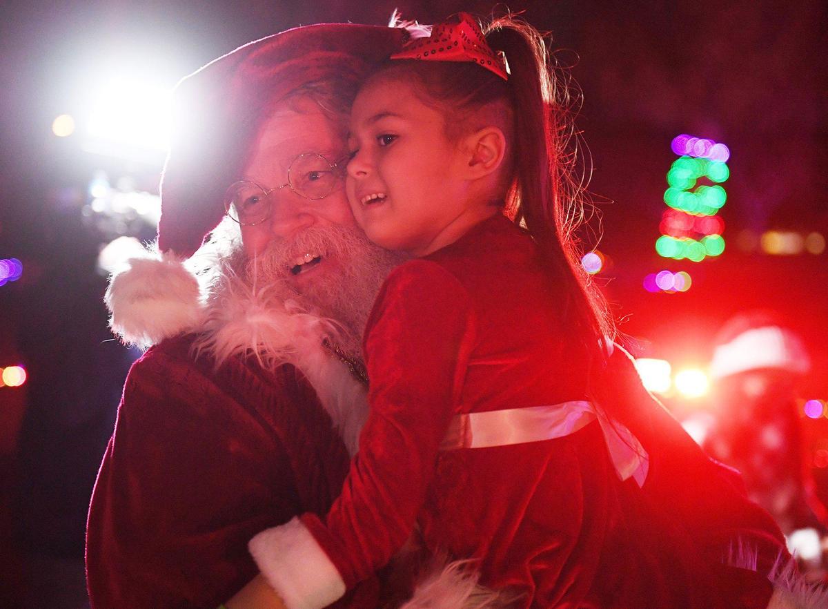 Arianna Jasso, age 6, is carried by Santa as she experiences a special surprise early Christmas, possibly her last, at Woodward Park Saturday night, Nov. 21, 2020 in Fresno. Arianna was diagnosed July 20 with a brain tumor called diffuse intrinsic pontine glioma (DIPG) which carries a life expectancy post-diagnoses of six to nine months. Local groups including law enforcement scrambled to arrange the event with the help of the City of Fresno.