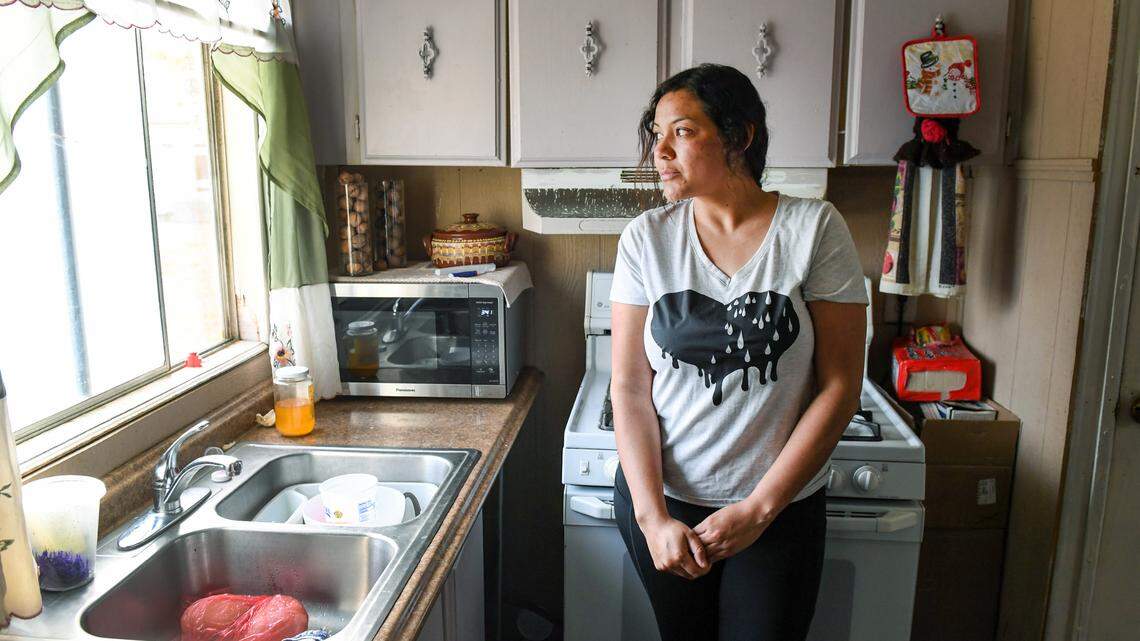Carolina, 34, stands in the kitchen of her mobile home in rural Fresno County on Tuesday, March 2, 2021. She asked that her last name not be published because she feared possible repercussions for her family.