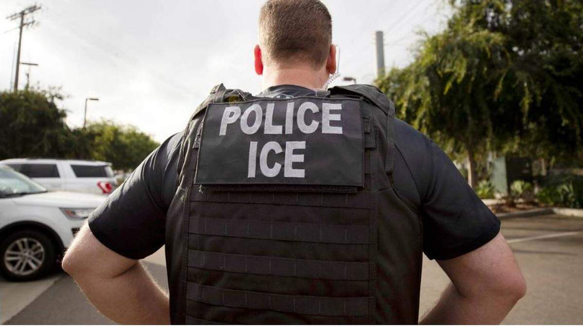 A U.S. Immigration and Customs Enforcement (ICE) officer looks on during an operation in Escondido, Calif., July 8, 2019.