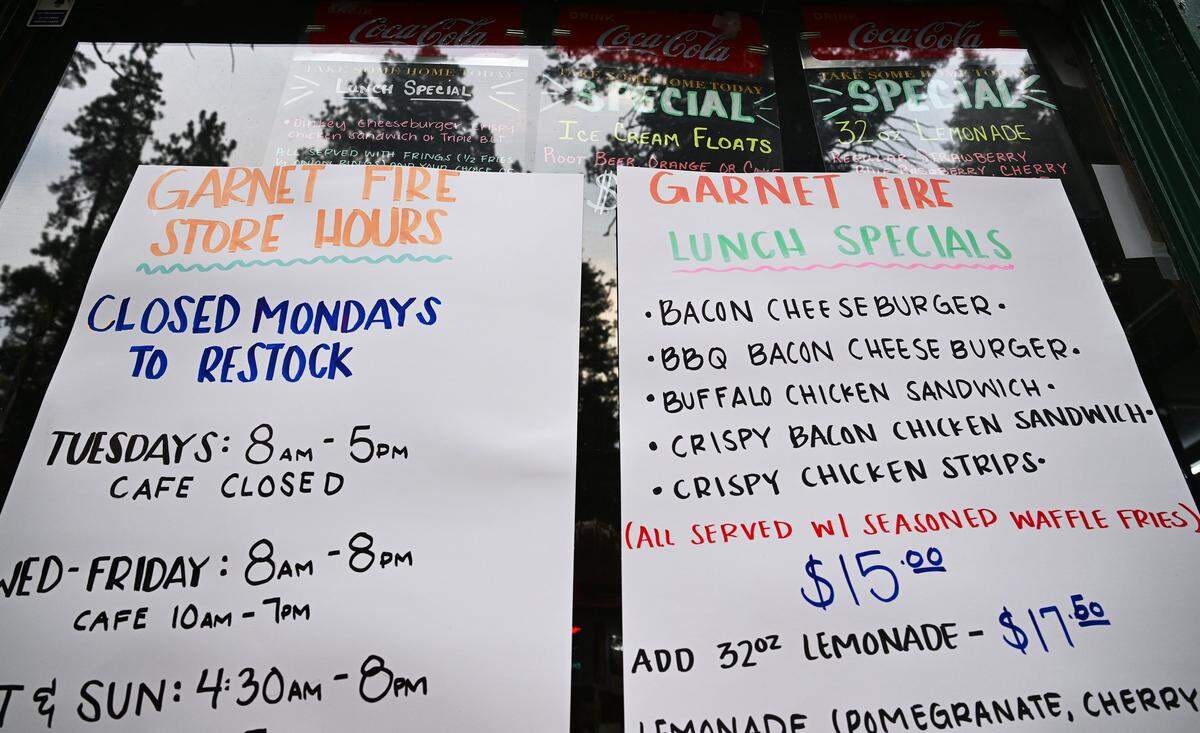 Garnet Fire store hours are posted at the closed DInkey Creek Inn's store as the Garnet Fire burns in the Sierra National Forest southeast of Shaver Lake Tuesday, Sept. 9, 2025.