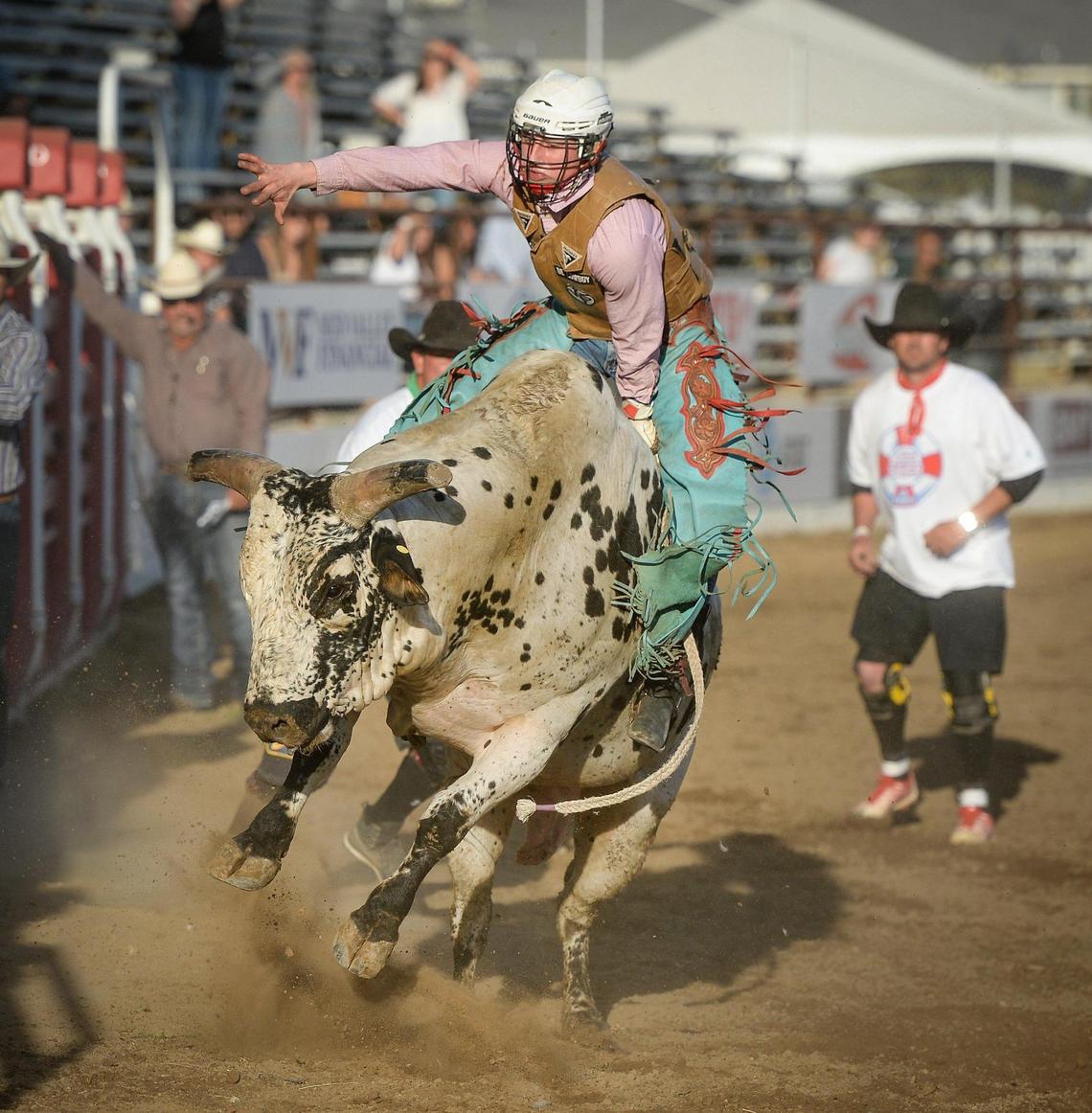 Pro bull rider Hunter Ball scores 85.50 on his ride of bull Tricky D during the PBR event on the first night of the Clovis Rodeo at the Clovis Rodeo Grounds on Wednesday, April 21, 2021.