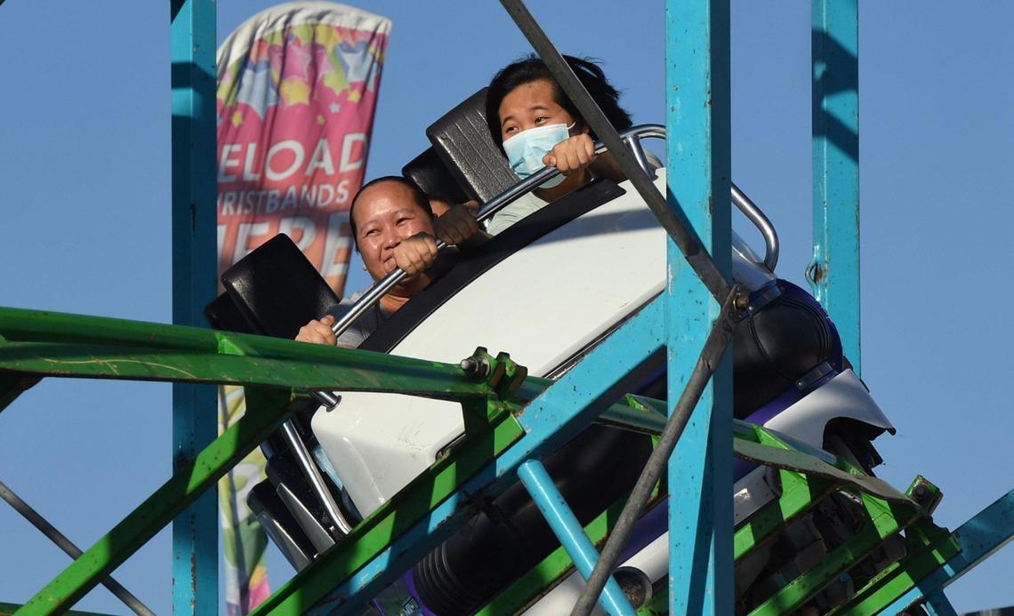 Riders on the eX Scream Machine rollercoaster ride on the Midway on opening day for the 2022 Big Fresno Fair Wednesday, Oct. 5, 2022 in Fresno. The Fair returns for its annual run October 5-16 with food, entertainment, exhibits and the Midway games and rides.