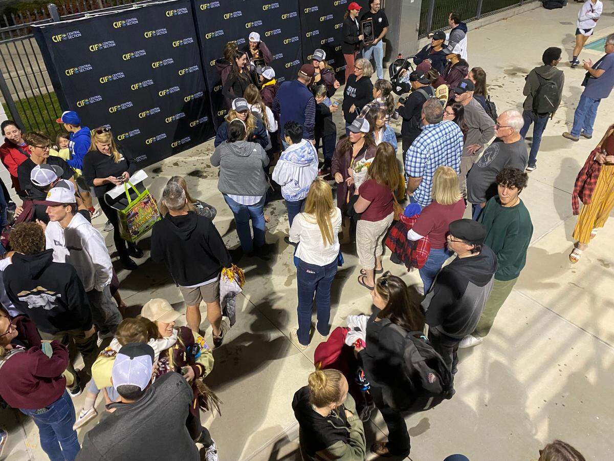 The Sierra High girls water polo team gathers with family and friends following a Central Section Division III title on Saturday, Nov. 11, 2023.