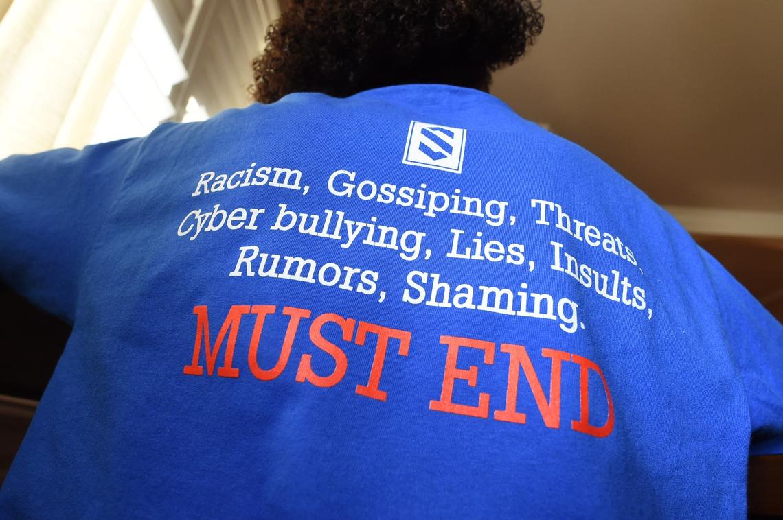 Tarrick Walker, 12, wears a T-shirt designed by his father, Marcel Walker, to address the issue of bullying after he was called the “N-word” recently on the playground of his Hanford school.